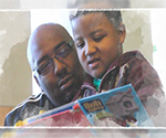 African American adult and child reading a book.